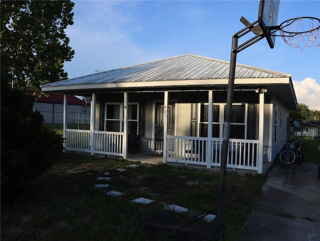 423 Midway Ave, Mascotte, FL 34753 - view of front facade featuring a porch and a metal roof