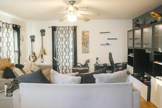 423 Midway Ave, Mascotte, FL 34753 - living room featuring ceiling fan and a desk