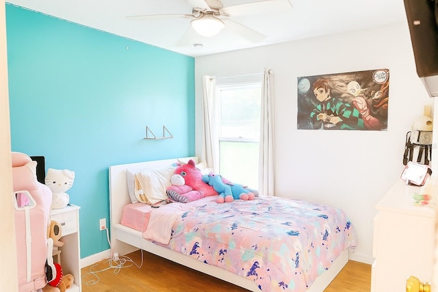 423 Midway Ave, Mascotte, FL 34753 - bedroom with wood finished floors and ceiling fan