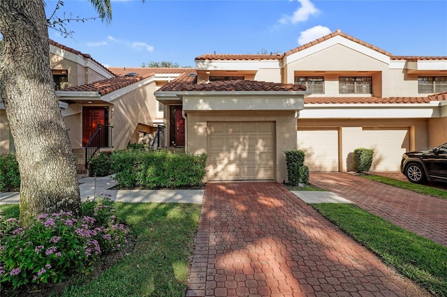 17340 Boca Club Blvd Unit 703, Boca Raton, FL 33487 - view of front of home with stucco siding, driveway, a garage, and a tiled roof