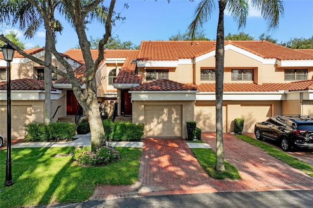 17340 Boca Club Blvd Unit 703, Boca Raton, FL 33487 - townhome / multi-family property featuring driveway, stucco siding, a tile roof, and a garage