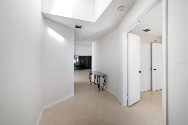 17340 Boca Club Blvd Unit 703, Boca Raton, FL 33487 - corridor with light tile patterned flooring and a skylight