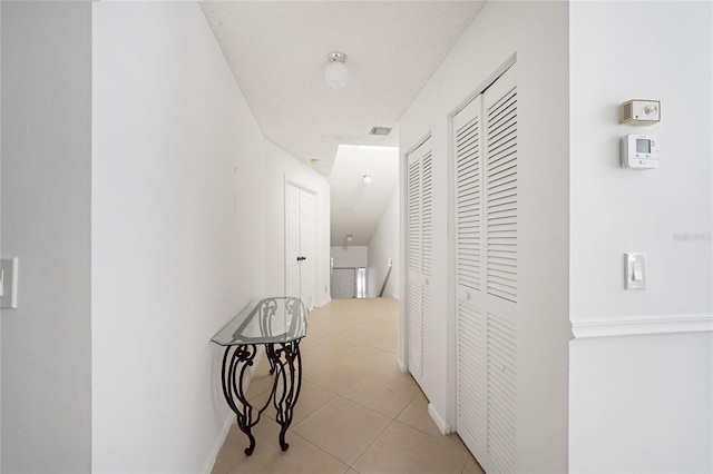 17340 Boca Club Blvd Unit 703, Boca Raton, FL 33487 - hall with light tile patterned flooring and an upstairs landing