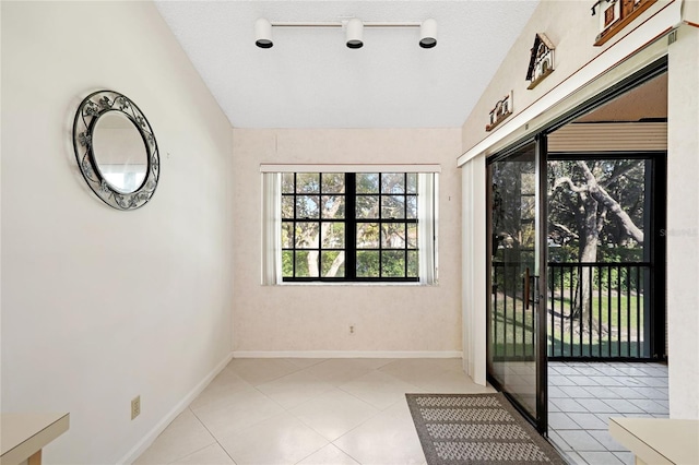 17340 Boca Club Blvd Unit 703, Boca Raton, FL 33487 - spare room with vaulted ceiling and light tile patterned floors