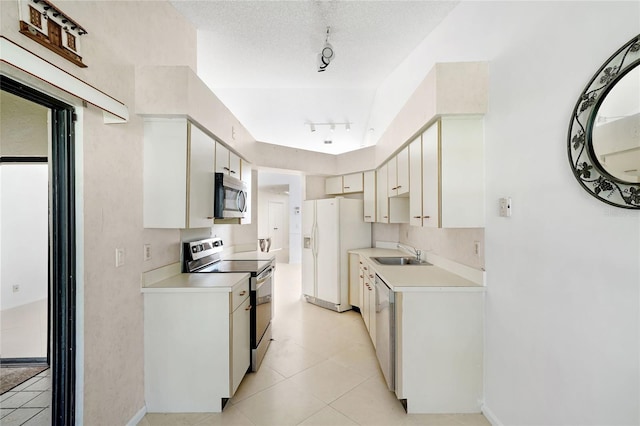 17340 Boca Club Blvd Unit 703, Boca Raton, FL 33487 - kitchen with stainless steel appliances, light countertops, rail lighting, light tile patterned flooring, and a textured ceiling