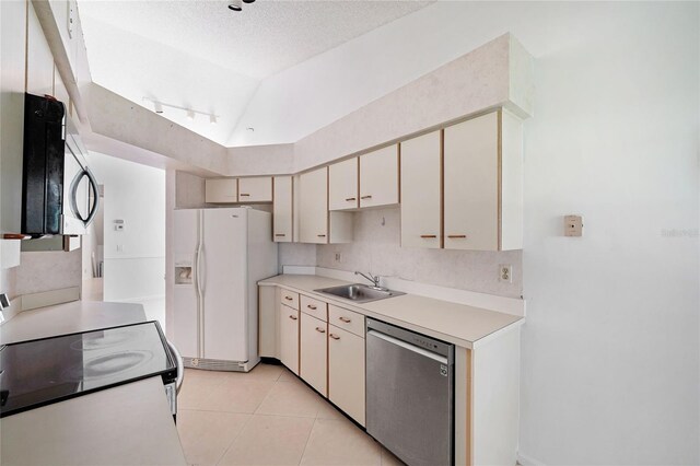 17340 Boca Club Blvd Unit 703, Boca Raton, FL 33487 - kitchen with appliances with stainless steel finishes, light tile patterned floors, light countertops, cream cabinets, and a textured ceiling