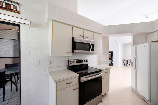 17340 Boca Club Blvd Unit 703, Boca Raton, FL 33487 - kitchen with appliances with stainless steel finishes, light countertops, and cream cabinets