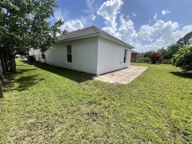 343 Marquee Dr, Kissimmee, FL 34758 - view of home's exterior with stucco siding and a patio