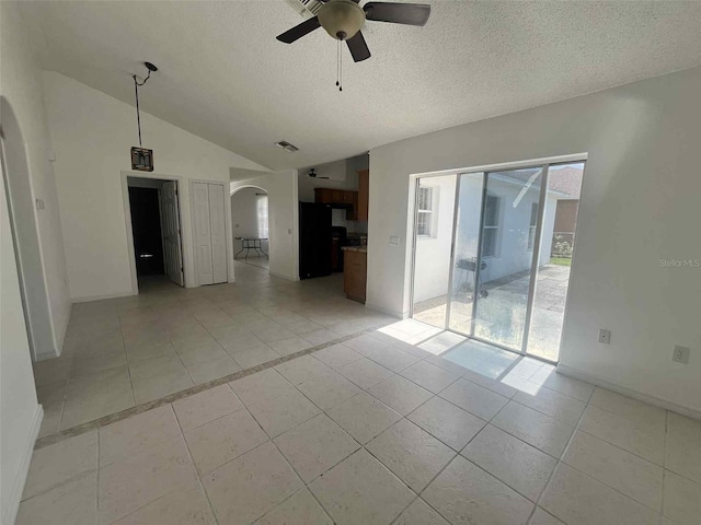 343 Marquee Dr, Kissimmee, FL 34758 - unfurnished room featuring arched walkways, ceiling fan, lofted ceiling, light tile patterned floors, and a textured ceiling