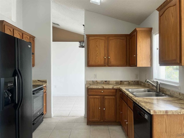 343 Marquee Dr, Kissimmee, FL 34758 - kitchen featuring black appliances, lofted ceiling, brown cabinetry, light countertops, and light tile patterned flooring