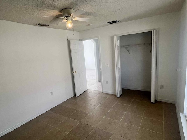 343 Marquee Dr, Kissimmee, FL 34758 - unfurnished bedroom featuring a ceiling fan, dark tile patterned floors, and a closet