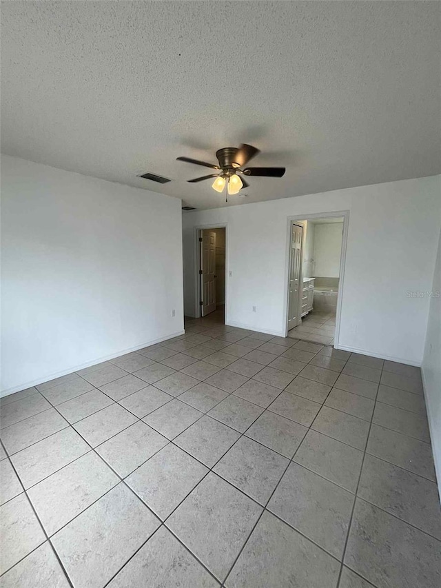 343 Marquee Dr, Kissimmee, FL 34758 - unfurnished room with light tile patterned floors, ceiling fan, and a textured ceiling