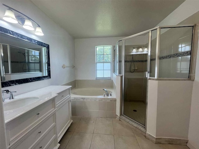 343 Marquee Dr, Kissimmee, FL 34758 - full bathroom featuring vanity, a garden tub, a shower stall, and tile patterned flooring