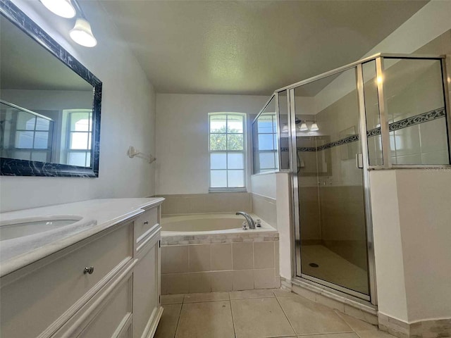 343 Marquee Dr, Kissimmee, FL 34758 - full bath with vanity, a bath, tile patterned flooring, and a stall shower
