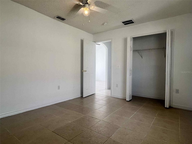 343 Marquee Dr, Kissimmee, FL 34758 - unfurnished bedroom featuring a textured ceiling, ceiling fan, and a closet