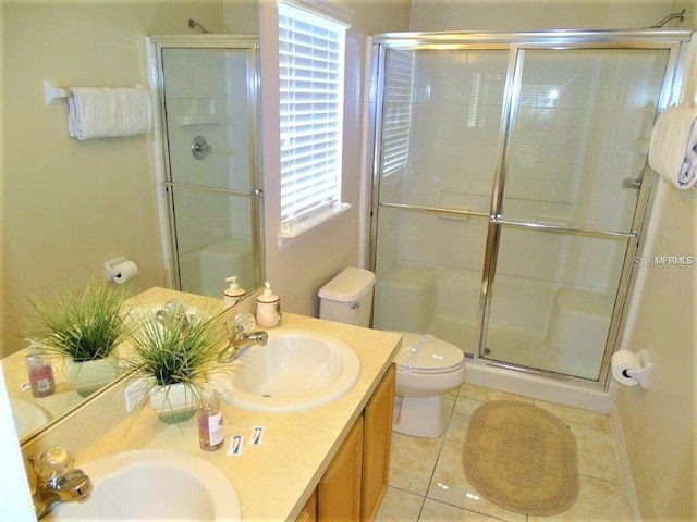 2281 Royal Ridge Dr, Davenport, FL 33896 - full bathroom with a stall shower, double vanity, and tile patterned floors