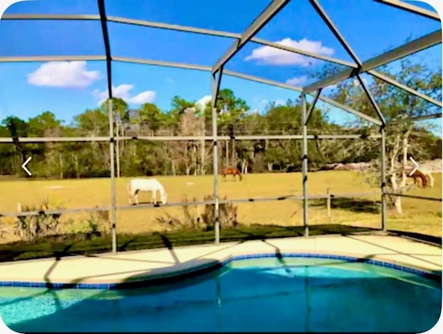 2281 Royal Ridge Dr, Davenport, FL 33896 - swimming pool featuring glass enclosure and a patio