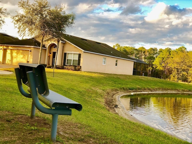 2281 Royal Ridge Dr, Davenport, FL 33896 - rear view of property featuring a lawn, stucco siding, and an attached garage
