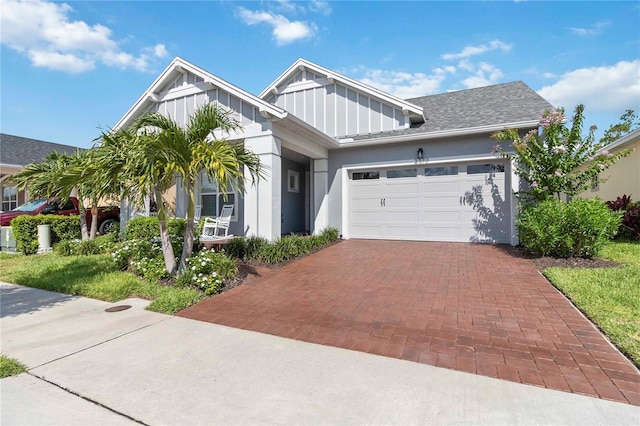 2772 Southland St, Saint Cloud, FL 34772 - view of front of property featuring board and batten siding, decorative driveway, an attached garage, and stucco siding