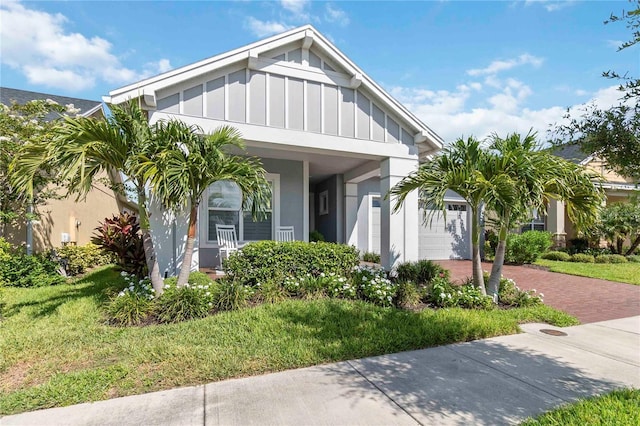 2772 Southland St, Saint Cloud, FL 34772 - view of front of home with board and batten siding, decorative driveway, stucco siding, an attached garage, and a front yard