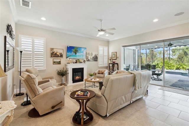 2772 Southland St, Saint Cloud, FL 34772 - living area featuring ceiling fan, a glass covered fireplace, recessed lighting, ornamental molding, and light tile patterned floors
