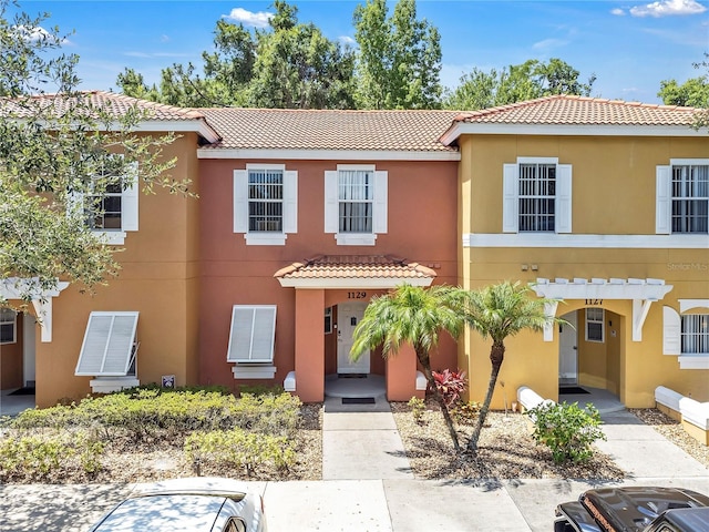1129 Park Ridge Cir, Kissimmee, FL 34746 - view of front of house with a tile roof and stucco siding