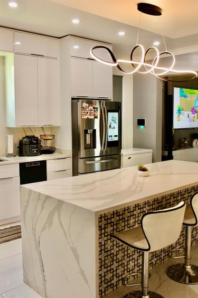 2805 Carter Grove Ln, Kissimmee, FL 34741 - kitchen with stainless steel fridge, modern cabinets, white cabinets, recessed lighting, and pendant lighting