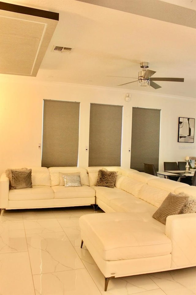 2805 Carter Grove Ln, Kissimmee, FL 34741 - living room with marble look tile flooring, ornamental molding, and ceiling fan