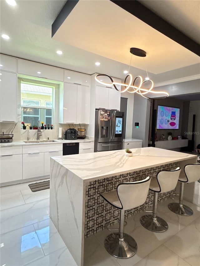 2805 Carter Grove Ln, Kissimmee, FL 34741 - kitchen featuring stainless steel fridge with ice dispenser, modern cabinets, white cabinetry, a kitchen bar, and recessed lighting