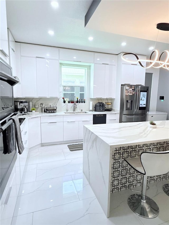 2805 Carter Grove Ln, Kissimmee, FL 34741 - kitchen featuring stainless steel appliances, modern cabinets, white cabinets, and recessed lighting