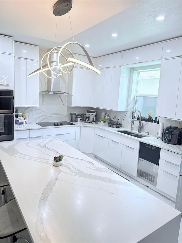 2805 Carter Grove Ln, Kissimmee, FL 34741 - kitchen with modern cabinets, black electric cooktop, white cabinetry, light stone counters, and recessed lighting