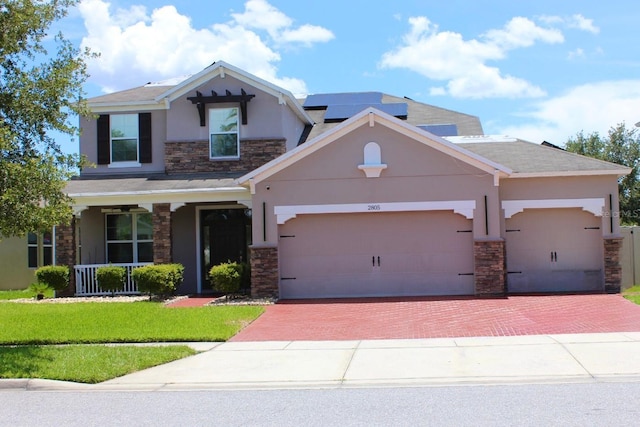 2805 Carter Grove Ln, Kissimmee, FL 34741 - craftsman-style house featuring stone siding, stucco siding, decorative driveway, and covered porch