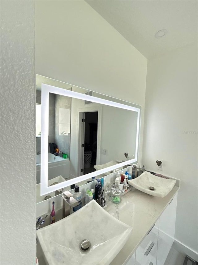 2805 Carter Grove Ln, Kissimmee, FL 34741 - full bathroom featuring double vanity and a tub