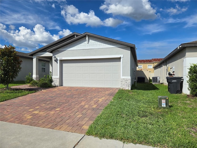 3839 Marbella Way, Davenport, FL 33897 - ranch-style home with stone siding, decorative driveway, a front yard, an attached garage, and stucco siding