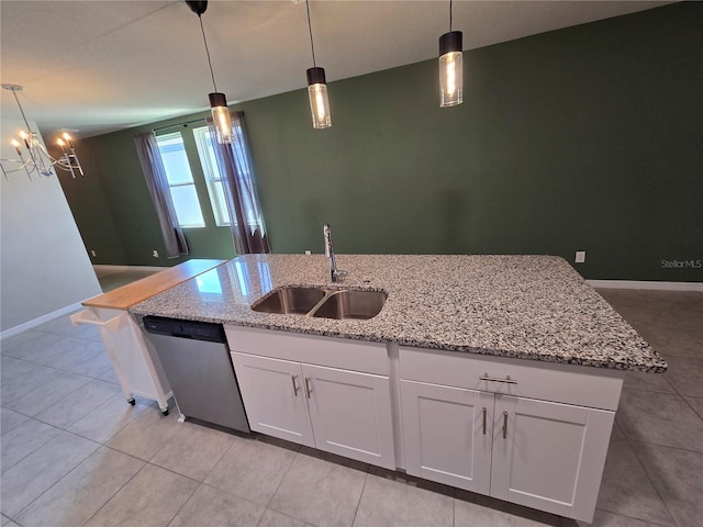 3839 Marbella Way, Davenport, FL 33897 - kitchen with stainless steel dishwasher, white cabinetry, hanging light fixtures, and light tile patterned flooring