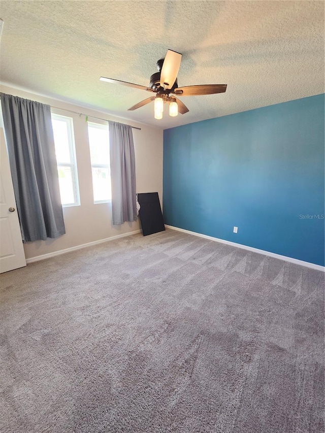 3839 Marbella Way, Davenport, FL 33897 - empty room with a ceiling fan, carpet floors, and a textured ceiling