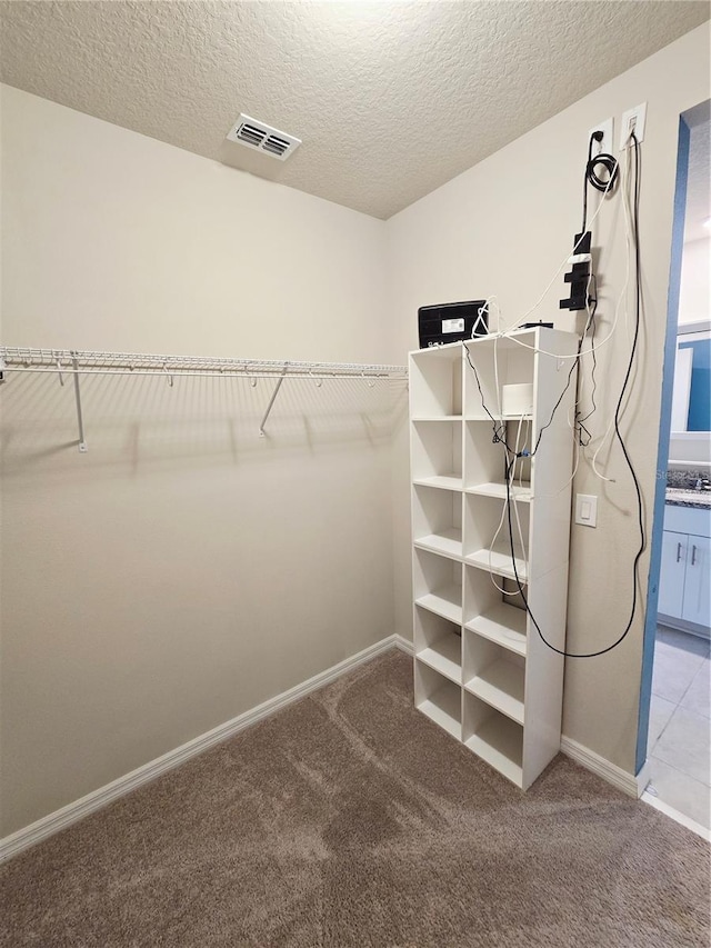 3839 Marbella Way, Davenport, FL 33897 - walk in closet featuring light colored carpet