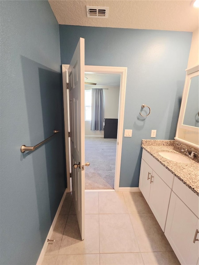 3839 Marbella Way, Davenport, FL 33897 - bathroom featuring vanity, tile patterned floors, and a textured ceiling