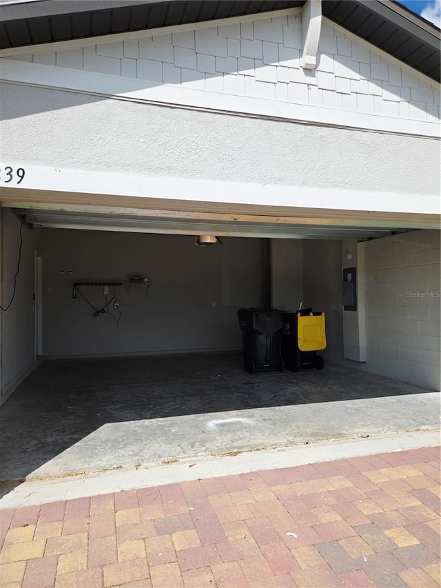 3839 Marbella Way, Davenport, FL 33897 - garage featuring a garage door opener, electric panel, and driveway