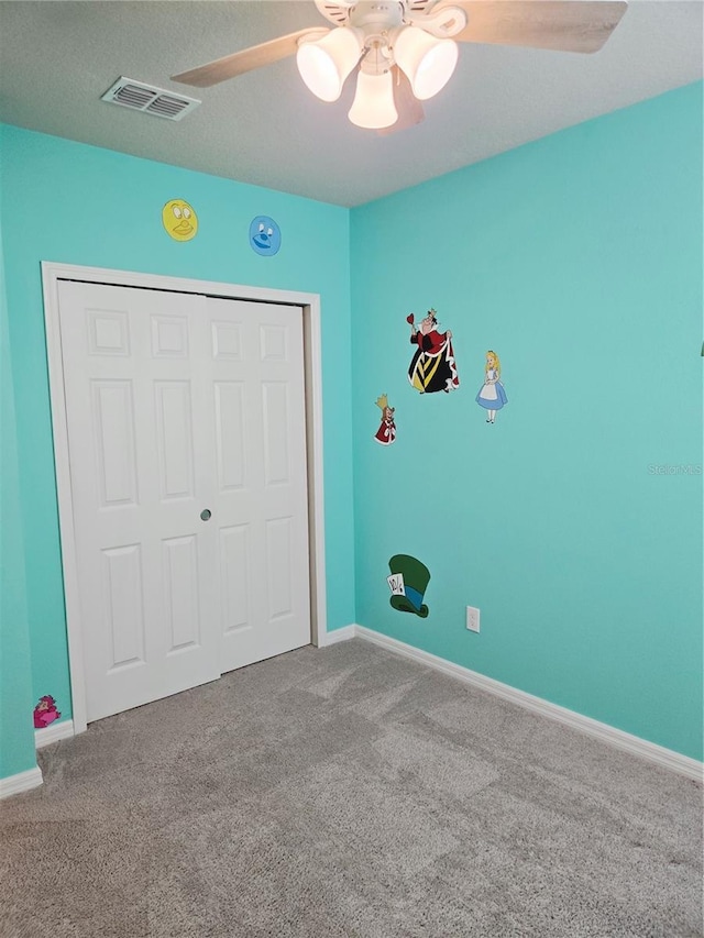 3839 Marbella Way, Davenport, FL 33897 - unfurnished bedroom featuring carpet, a closet, and a ceiling fan