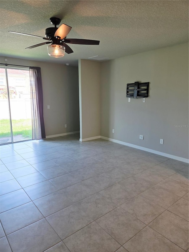 3839 Marbella Way, Davenport, FL 33897 - empty room with a textured ceiling, ceiling fan, and light tile patterned floors