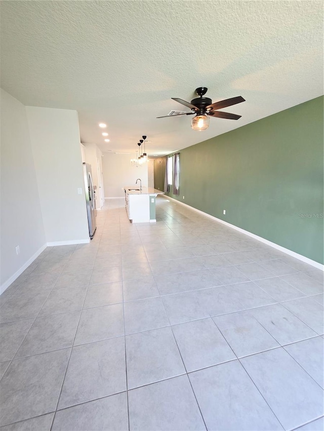 3839 Marbella Way, Davenport, FL 33897 - unfurnished living room featuring ceiling fan, light tile patterned flooring, and a textured ceiling