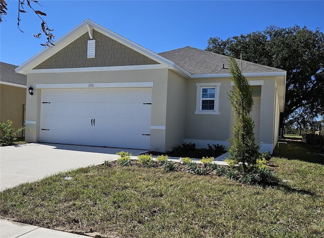 1370 Holodak Dr, Davenport, FL 33837 - view of front facade with driveway, a garage, stucco siding, and roof with shingles