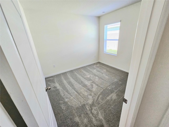 1370 Holodak Dr, Davenport, FL 33837 - unfurnished bedroom featuring carpet floors and baseboards