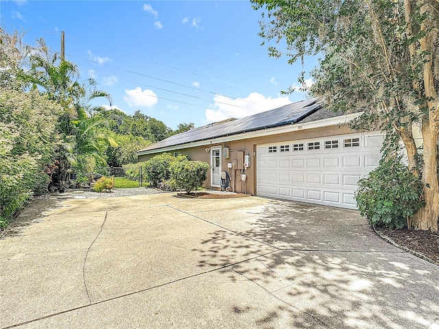 3158 Forest Breeze Way, Saint Cloud, FL 34771 - view of side of home with driveway, solar panels, and an attached garage