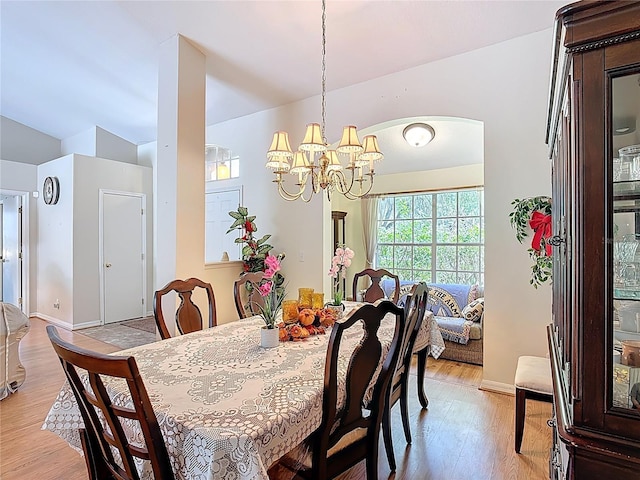3158 Forest Breeze Way, Saint Cloud, FL 34771 - dining space featuring light wood-style floors, a chandelier, and lofted ceiling