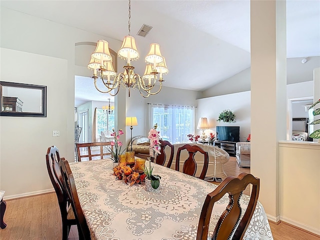 3158 Forest Breeze Way, Saint Cloud, FL 34771 - dining area with light wood-style flooring, a chandelier, and vaulted ceiling