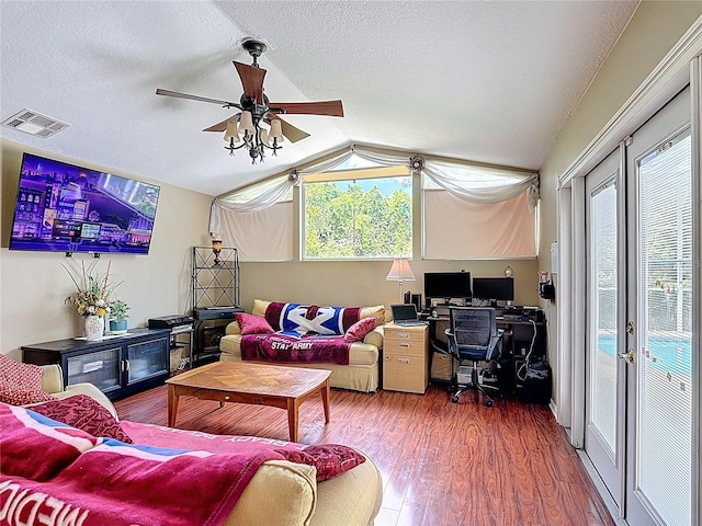 3158 Forest Breeze Way, Saint Cloud, FL 34771 - living area with wood finished floors, an office area, vaulted ceiling, plenty of natural light, and a textured ceiling