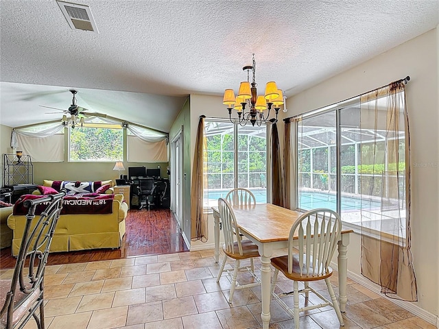 3158 Forest Breeze Way, Saint Cloud, FL 34771 - dining area with a chandelier, a ceiling fan, a textured ceiling, and lofted ceiling
