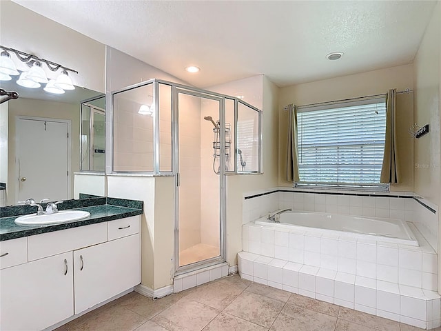 3158 Forest Breeze Way, Saint Cloud, FL 34771 - bathroom with a garden tub, a shower stall, vanity, tile patterned flooring, and a textured ceiling